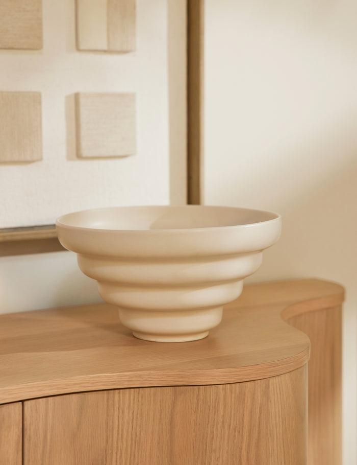 #color::ivory | Cascading matte ceramic serving bowl styled on the Cora Sideboard