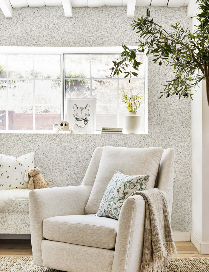 #color::blue | The Dainty Leaves floral Wallpaper by Rylee + Cru is in a nursery with a natural linen swivel chair and a woven brown rug