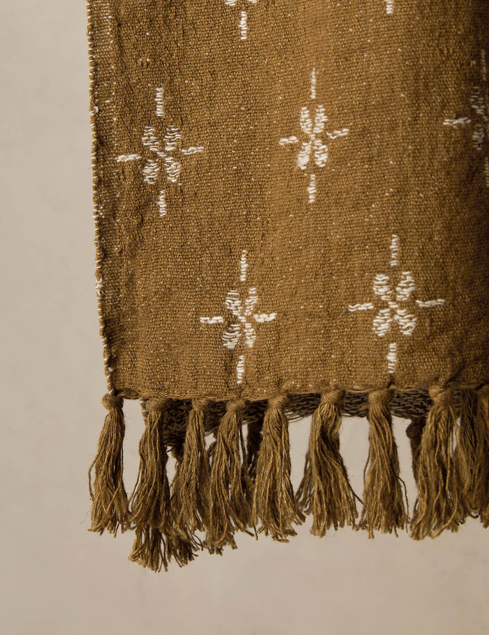 #color::marigold-and-ivory | Close up of the fringe of the Fania lightweight linen-cotton blend floral motif throw.