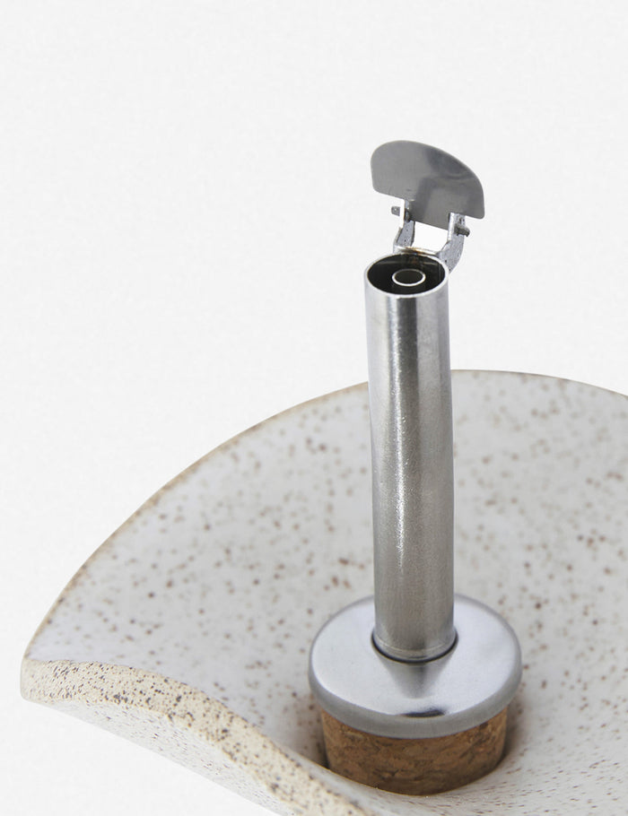 #color::sand | Close-up of the metallic spout on the Flora speckled eggshell glazed oil cruet by SIN ceramics