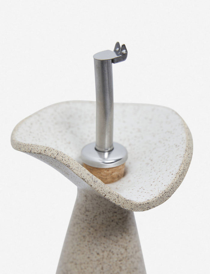 #color::sand | Close-up of the metallic spout on the Flora speckled eggshell glazed oil cruet by SIN ceramics