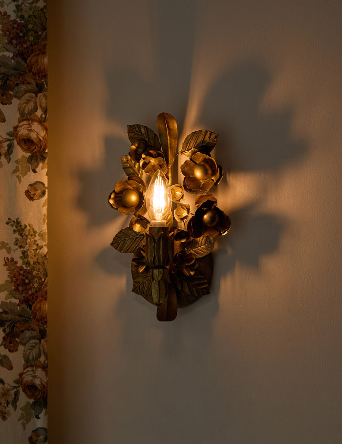 #color::aged-brass | Garda ornate floral metalwork wall sconce by Heidi Caillier with the light on