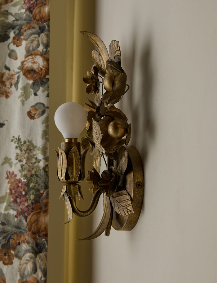 #color::aged-brass | Angled side view of the Garda ornate floral metalwork wall sconce by Heidi Caillier