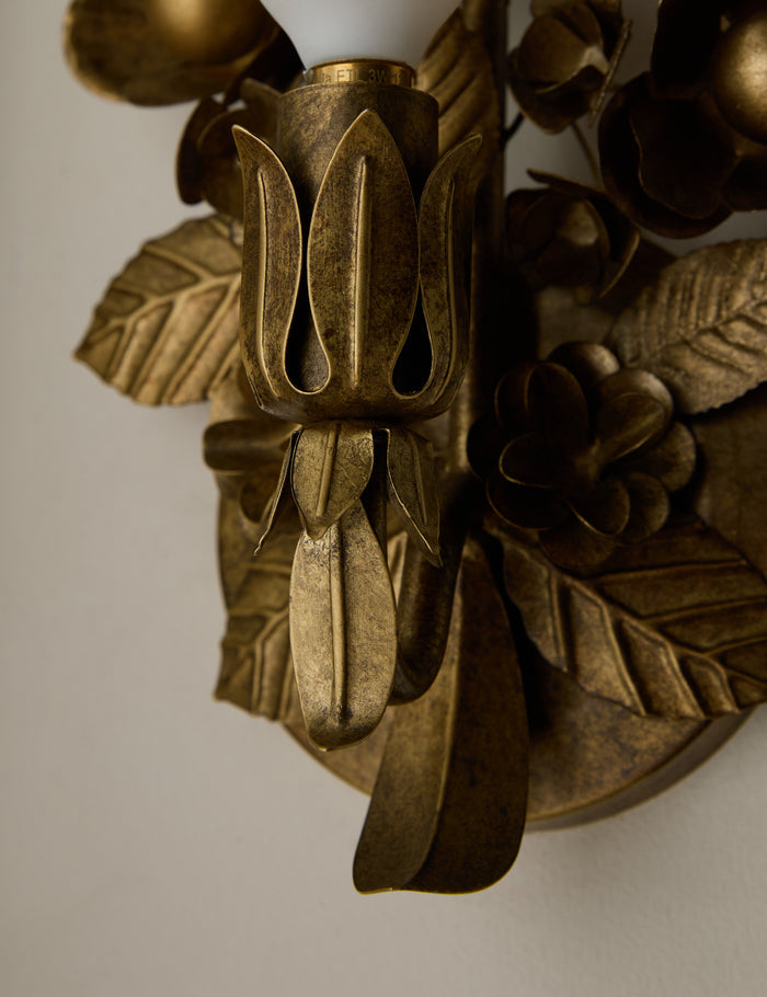 #color::aged-brass | Close up of the Garda ornate floral metalwork wall sconce by Heidi Caillier