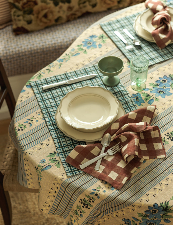 #color::azure #size::large #size::small | Dining table and place setting styled with the Golden floral stripe linen tablecloth by Heidi Caillier