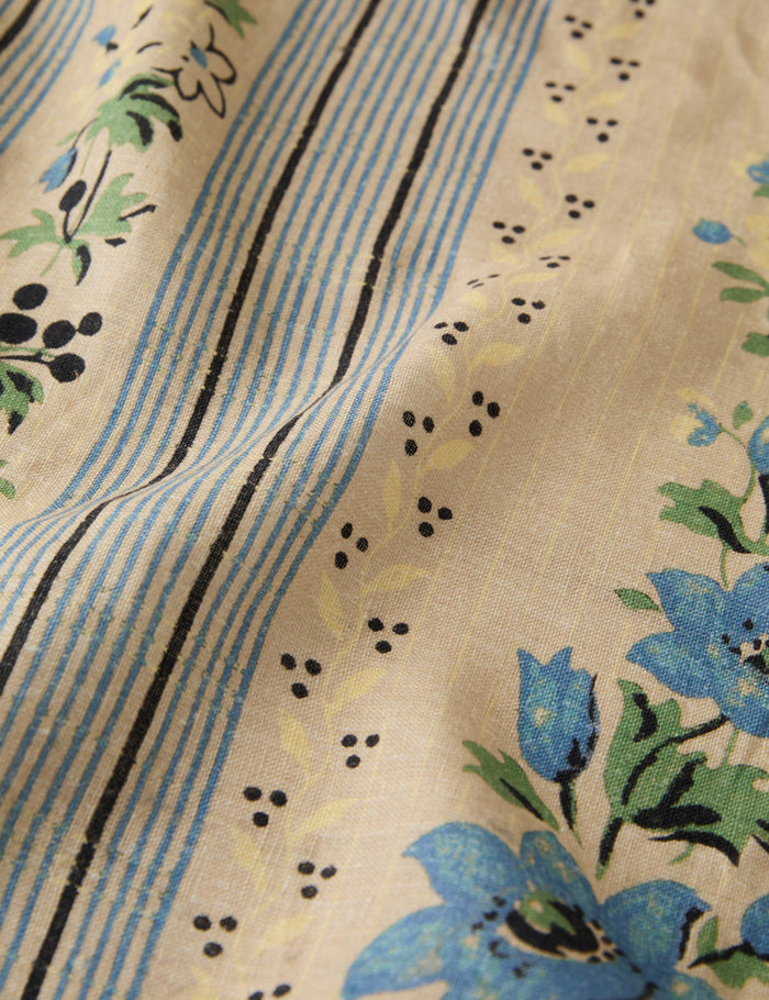 #color::azure #size::large #size::small | Close up of the pattern of the Golden floral stripe linen tablecloth by Heidi Caillier