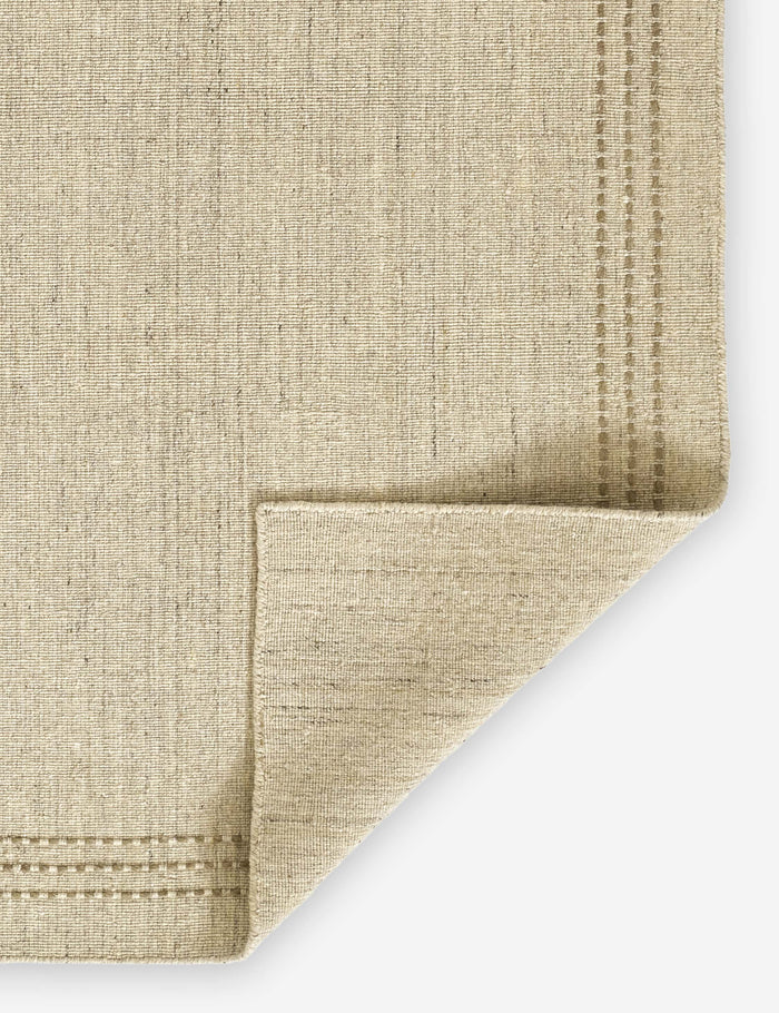 #size::2-3--x-8--runner #size::3-6--x-5-6- #size::5--x-8- #size::8--x-10- #size::9--x-12- | Corner of the Greco low pile wool rug with accent border stitching.