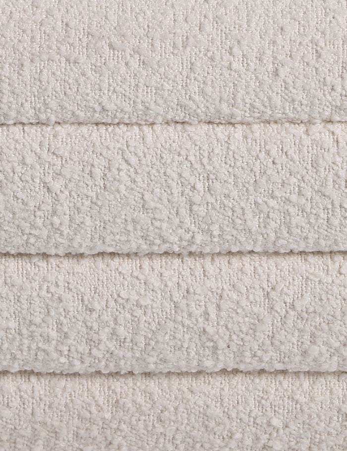 #color::ivory-boucle | Close up of the Leon textural boucle channel tufted waterfall ottoman by Carly Cushnie.