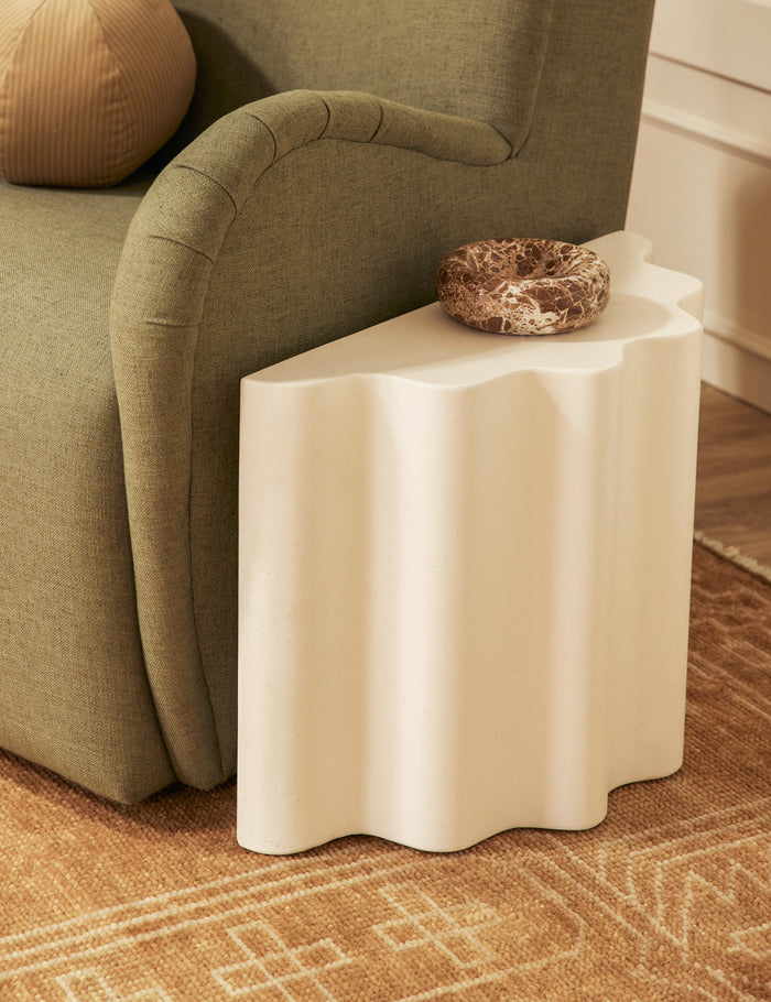#color::ivory #size::short | Lune half-moon, scalloped concrete side table styled next to a chair