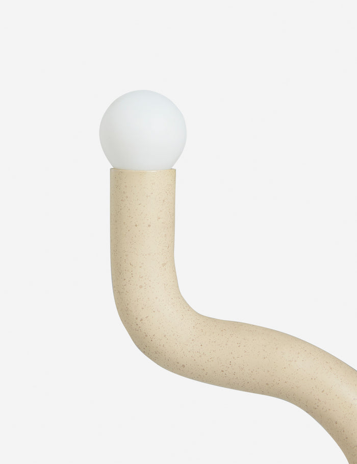 #color::sand | Close up view of the Noor sculptural, wavy table lamp