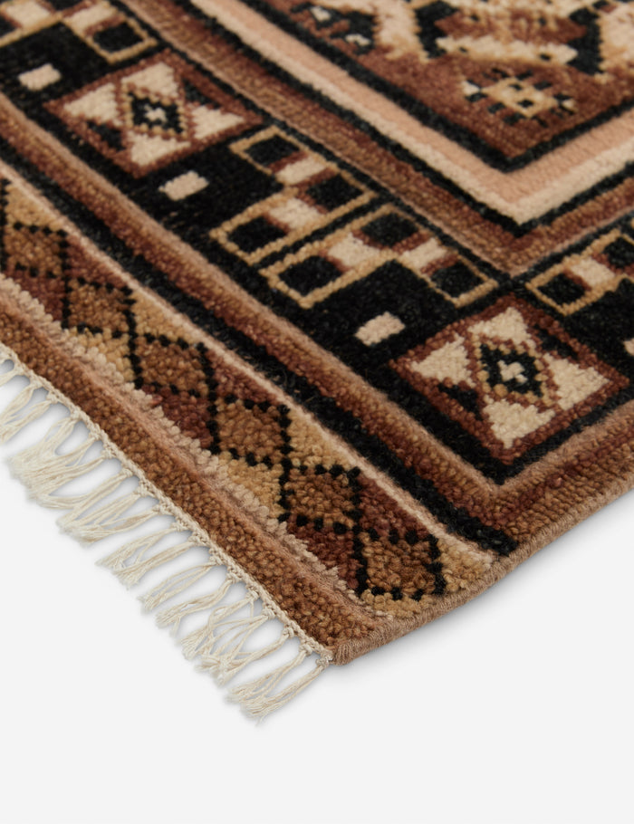 #color::taupe #size::2--x-3- #size::2-6--x-8--runner #size::3--x-5- #size::4--x-6- #size::5--x-8- #size::6--x-9- #size::8--x-10- #size::9--x-12- #size::10--x-14- #size::12--x-15- | Close up of the corner of the Ovidi heritage motif hand-knotted wool rug.