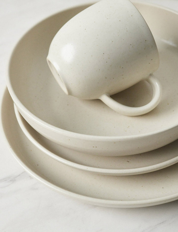 #color::vanilla #style::5-piece-set | Angled view of the Pacifica Vanilla-toned Dinnerware 5-Piece Place Setting by Casafina