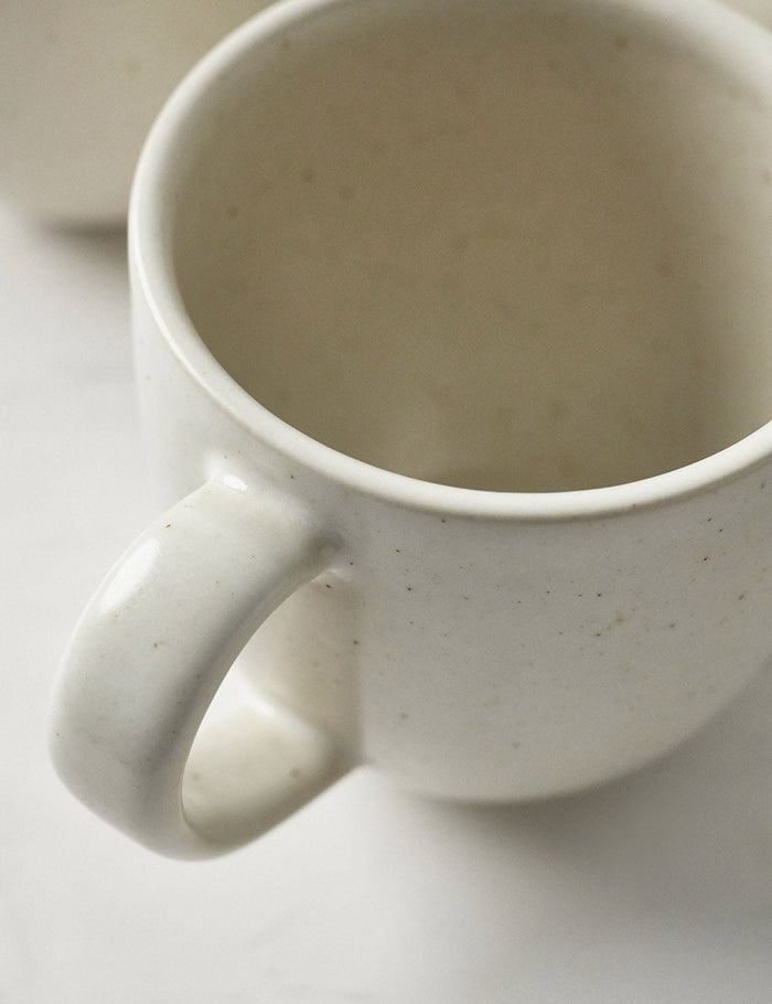 #color::vanilla #style::5-piece-set | Close-up of the mug in the Pacifica Vanilla-toned Dinnerware 5-Piece Place Setting by Casafina