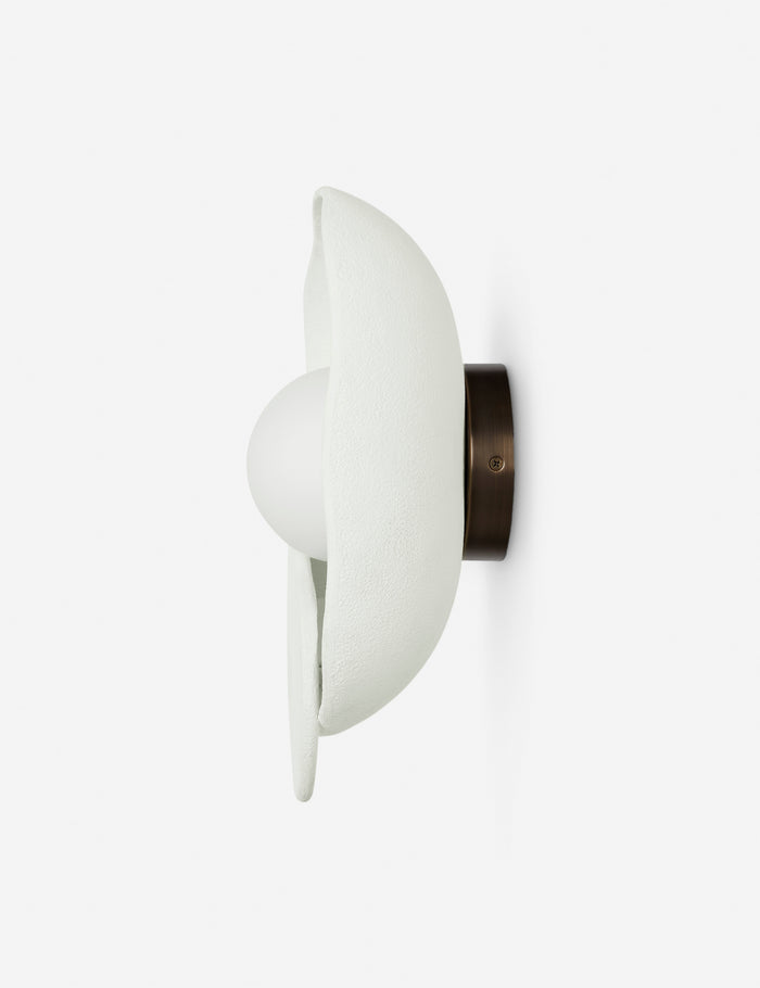 | Side view of the Soft Petal matte white floral silhouette wall sconce light